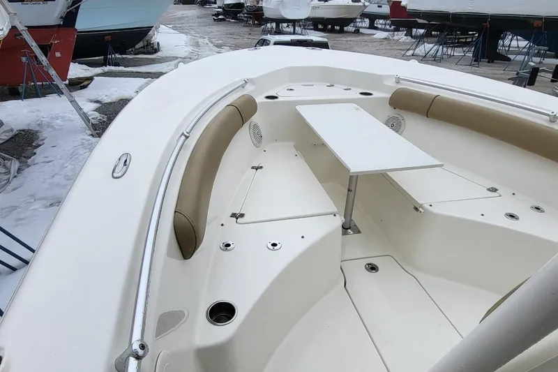 Slide: The Image of 2019 Key West 244 Center Console boat with seating and table, docked in snowy marina. - 8