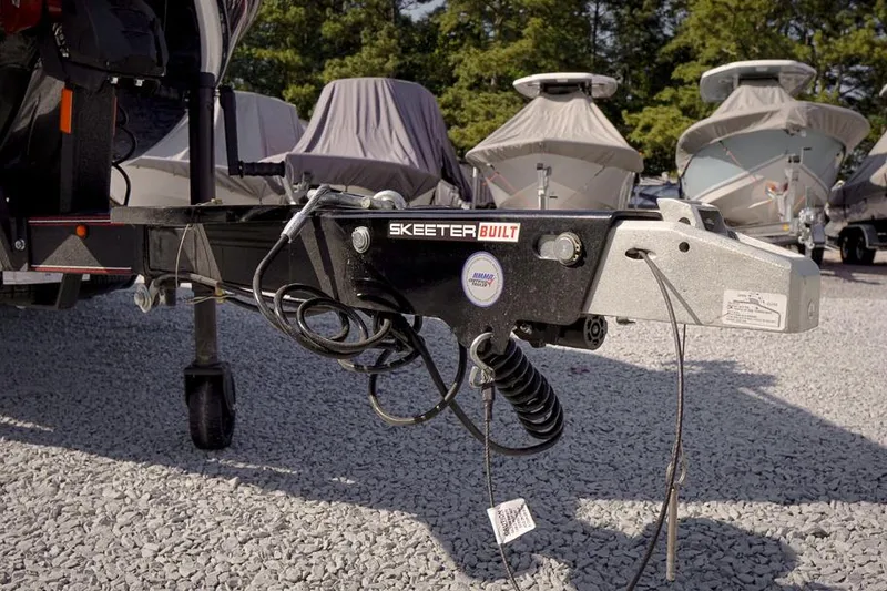 Slide: The Image of Trailer hitch of a 2026 Skeeter ZX200 boat on gravel lot. - 12