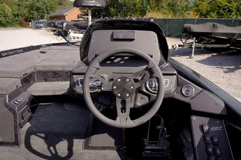Slide: The Image of 2026 Skeeter ZX200 boat cockpit with steering wheel and control panel. - 16