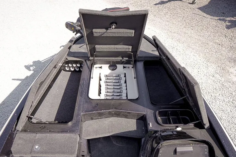 Slide: The Image of 2026 Skeeter ZX200 boat interior with open storage compartments and organized tackle boxes. - 23