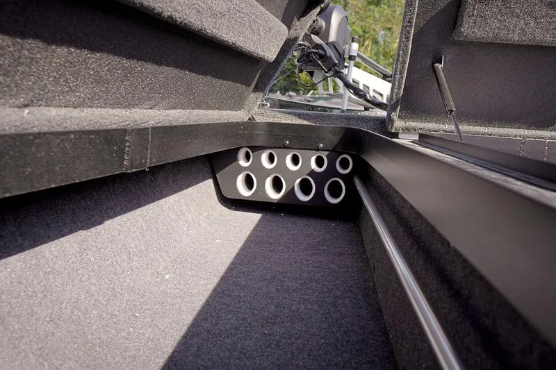 Slide: The Image of Interior view of 2026 Skeeter ZX200 boat storage compartment with rod holders. - 24