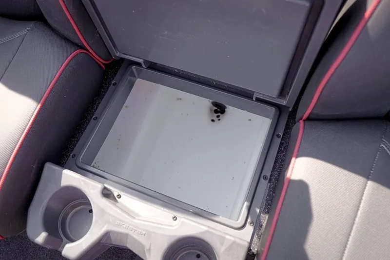 Slide: The Image of Open storage compartment in 2026 Skeeter ZX200 boat with cup holders. - 29