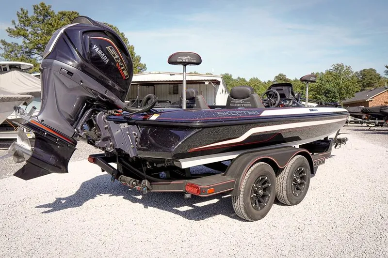 Slide: The Image of 2026 Skeeter ZX200 boat with Yamaha engine on a trailer in a sunny outdoor setting. - 3