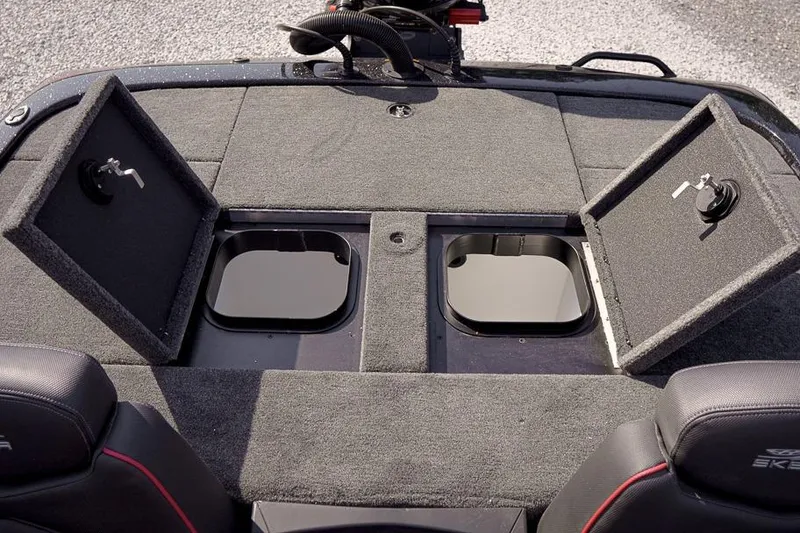 Slide: The Image of 2026 Skeeter ZX200 boat storage compartments with open lids on a carpeted deck. - 30