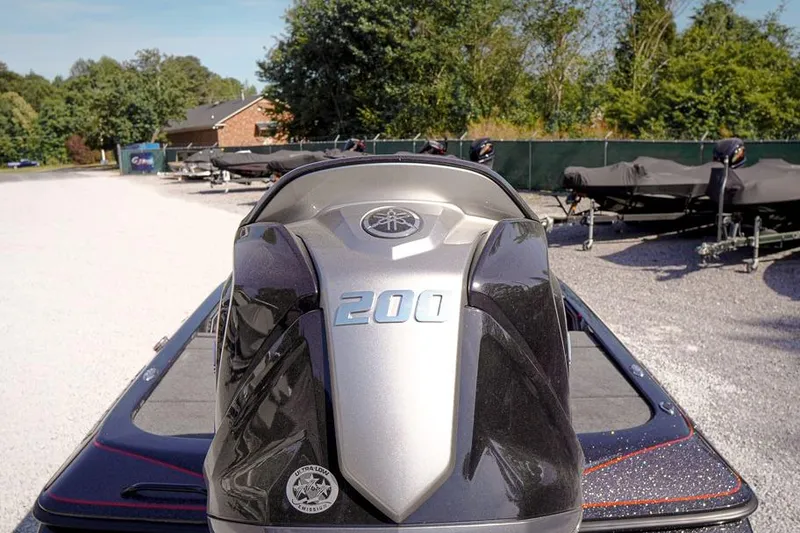 Slide: The Image of 2026 Skeeter ZX200 boat engine, parked outdoors on gravel, surrounded by trees and trailers. - 6