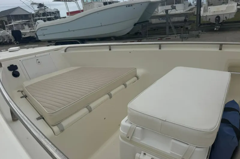 Slide: The Image of 2001 Scout 185 Sportfish boat interior with cushioned seating and storage. - 10