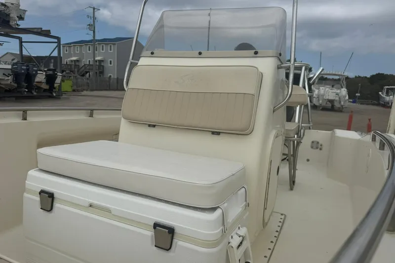 Slide: The Image of 2001 Scout 185 Sportfish boat interior with seating and console, docked outdoors. - 11