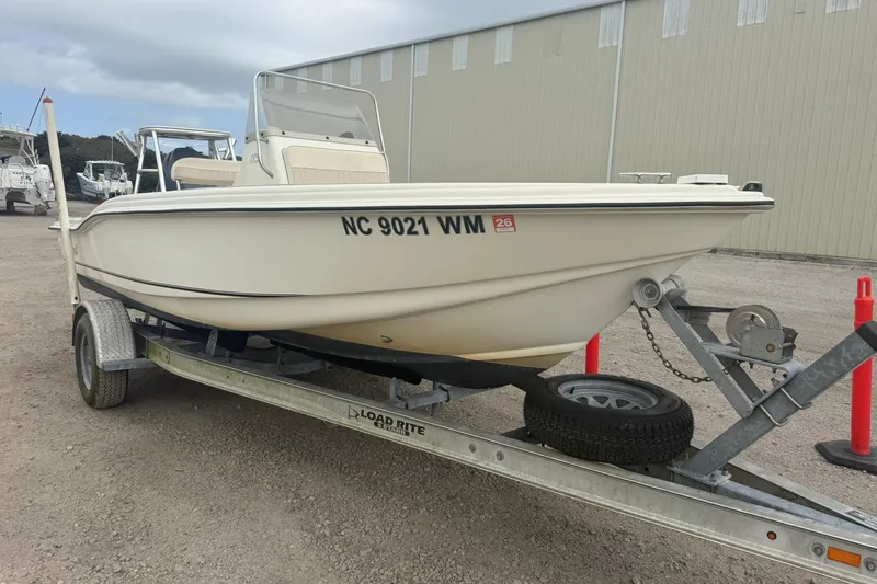 Slide: The Image of 2001 Scout 185 Sportfish boat on trailer, parked outdoors. - 13