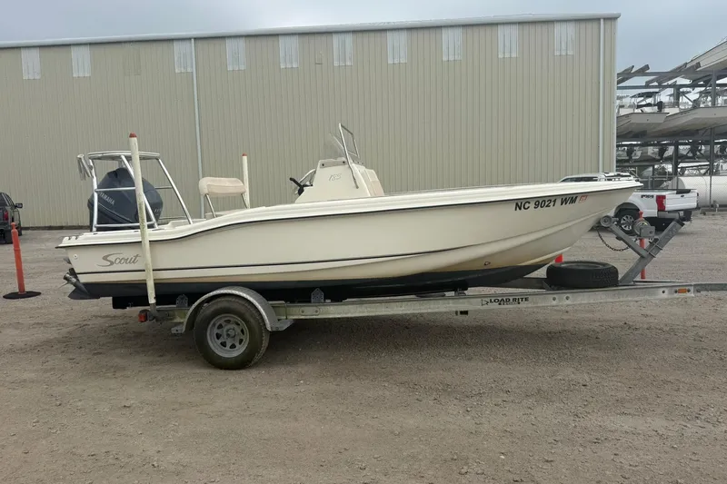 Slide: The Image of 2001 Scout 185 Sportfish boat on trailer, parked outdoors. - 14