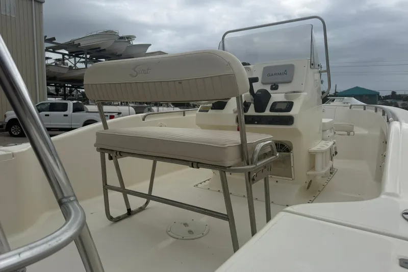 Slide: The Image of 2001 Scout 185 Sportfish boat interior with Garmin navigation system, docked under cloudy skies. - 6