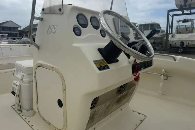 Slide: The Image of 2001 Scout 185 Sportfish boat console with steering wheel and gauges. - 8