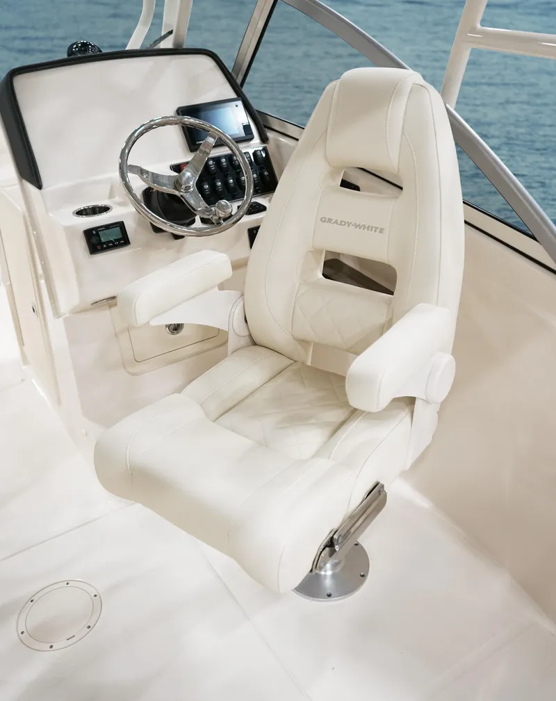 Slide: The Image of 2025 Grady-White Freedom 235 boat interior with helm and ocean view. - 10