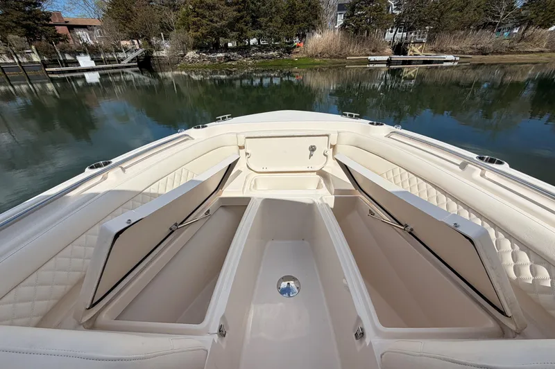 Slide: The Image of 2025 Grady-White Freedom 235 boat interior with open storage compartments. - 19