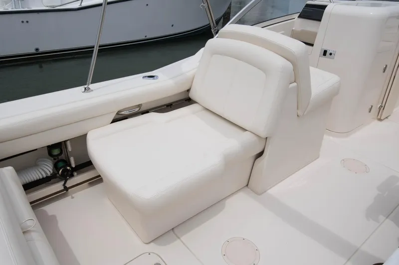 Slide: The Image of Open storage compartment on 2025 Grady-White Freedom 235 boat, docked near water. - 6