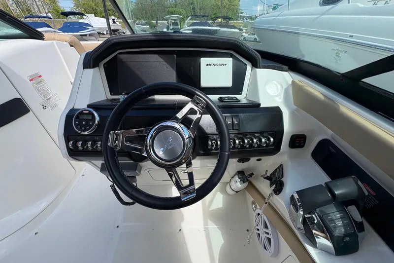 Slide: The Image of Steering console of a 2015 Sea Ray 300 SLX boat with Mercury controls. - 15