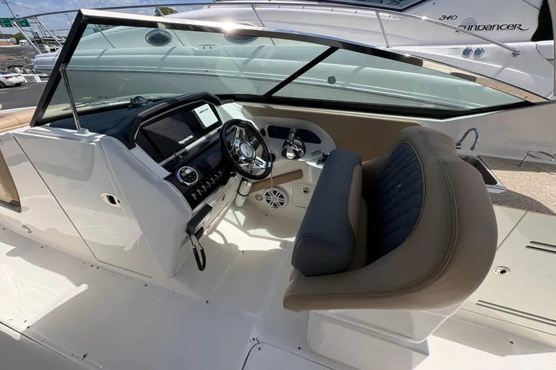 Slide: The Image of Interior view of 2015 Sea Ray 300 SLX boat cockpit with steering wheel and dashboard. - 16
