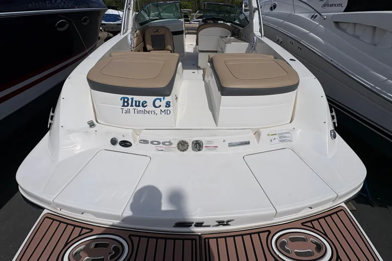 Slide: The Image of 2015 Sea Ray 300 SLX boat docked, featuring tan seating and "Blue C's" lettering. - 19