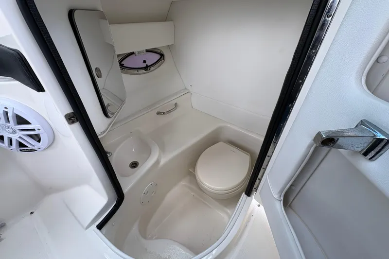 Slide: The Image of Interior of 2015 Sea Ray 300 SLX boat bathroom with toilet and sink. - 20