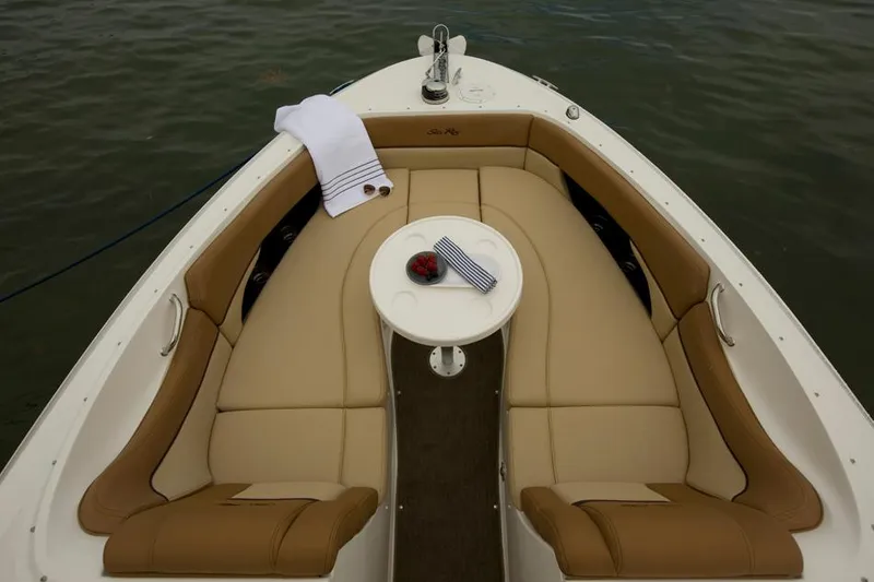 Slide: The Image of 2015 Sea Ray 300 SLX boat interior with seating, docked by a serene waterfront. - 3