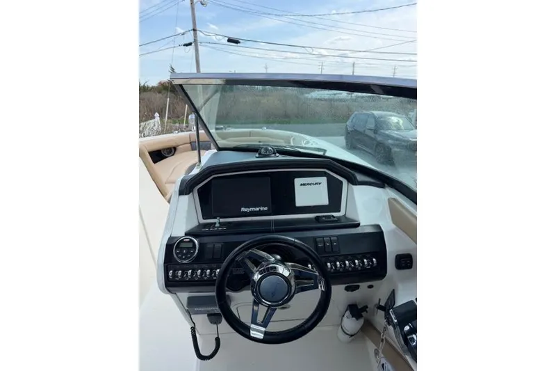 Slide: The Image of Cockpit view of 2015 Sea Ray 300 SLX boat with steering wheel and navigation system. - 4
