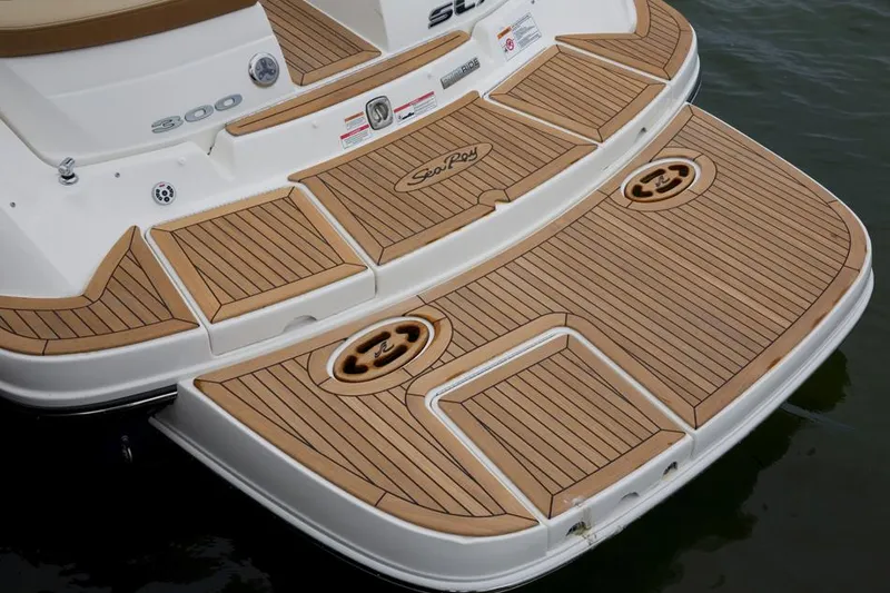Slide: The Image of Manufacturer Provided Image: 2015 Sea Ray 300 SLX boat with tan seating and a small table on the water. - 9