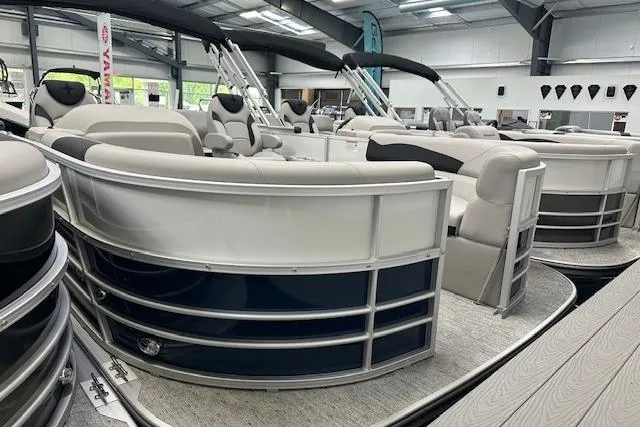 Slide: The Image of 2026 Berkshire 22UL LE B pontoon boat in showroom, featuring luxurious seating and modern design. - 11