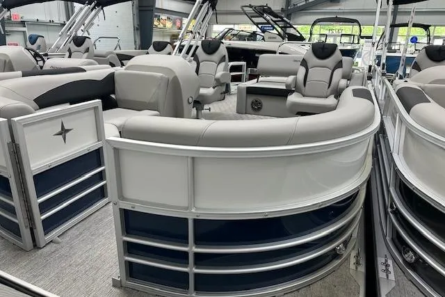 Slide: The Image of 2026 Berkshire 22UL LE B pontoon boat with luxurious seating and modern design in a showroom. - 12