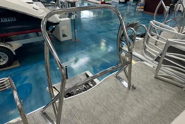 Slide: The Image of 2026 Berkshire 22UL LE B boat interior with stainless steel railing and blue flooring. - 6
