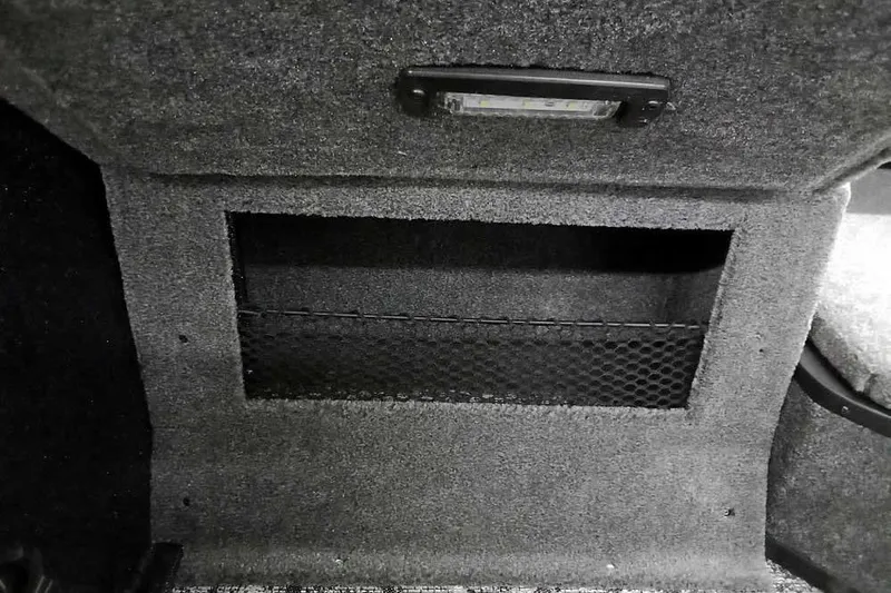 Slide: The Image of Interior storage compartment of 2026 Ranger VX1888 WT with netting and light. - 18