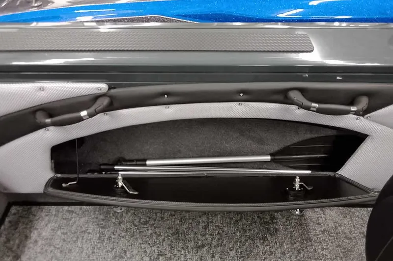 Slide: The Image of Interior storage compartment of 2026 Ranger VX1888 WT boat, featuring paddle storage. - 19