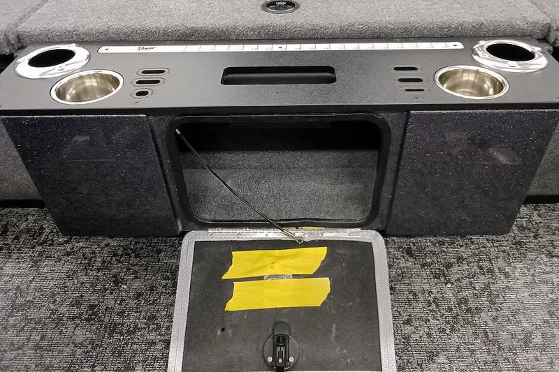 Slide: The Image of 2026 Ranger VX1888 WT boat interior with cup holders and storage compartment. - 26