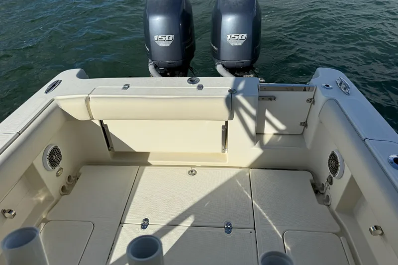 Slide: The Image of 2013 Chris-Craft Catalina 26 boat deck with twin 150 horsepower engines on water. - 14