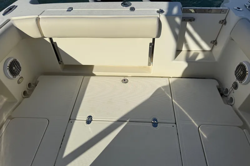 Slide: The Image of 2013 Chris-Craft Catalina 26 boat interior with seating and storage compartments. - 15