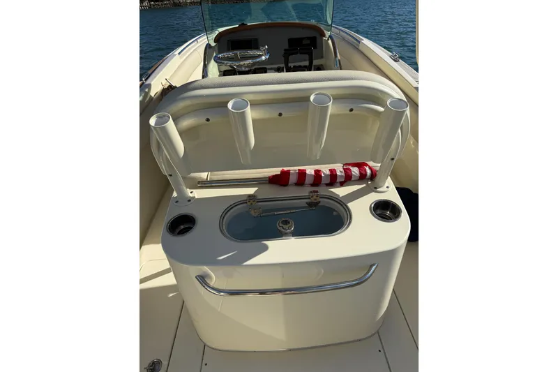 Slide: The Image of 2013 Chris-Craft Catalina 26 boat interior with rod holders and storage compartment. - 16