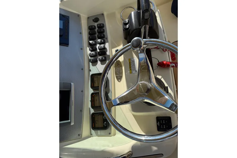 Slide: The Image of 2013 Chris-Craft Catalina 26 helm with steering wheel and control panel. - 17