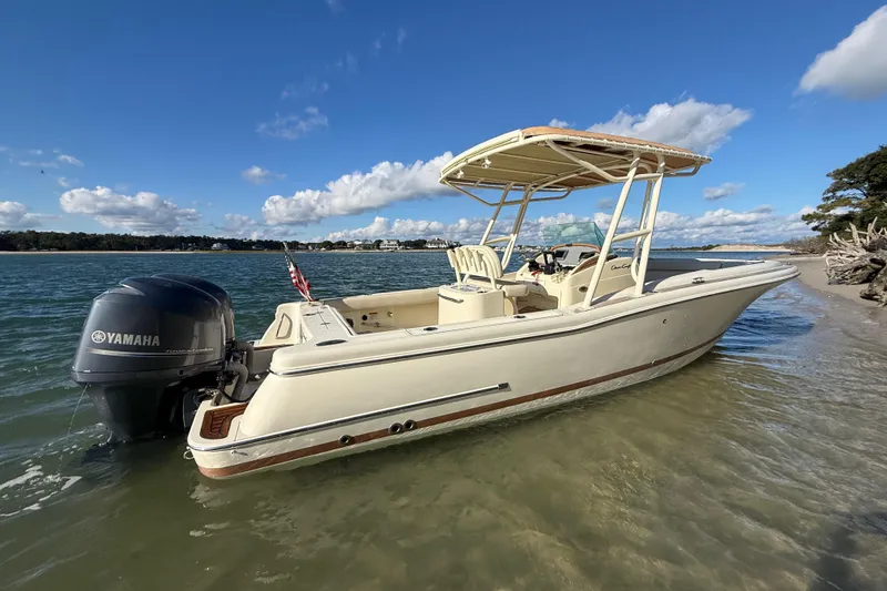 Slide: The Image of 2013 Chris-Craft Catalina 26 boat with Yamaha engine on a sunny shoreline. - 2