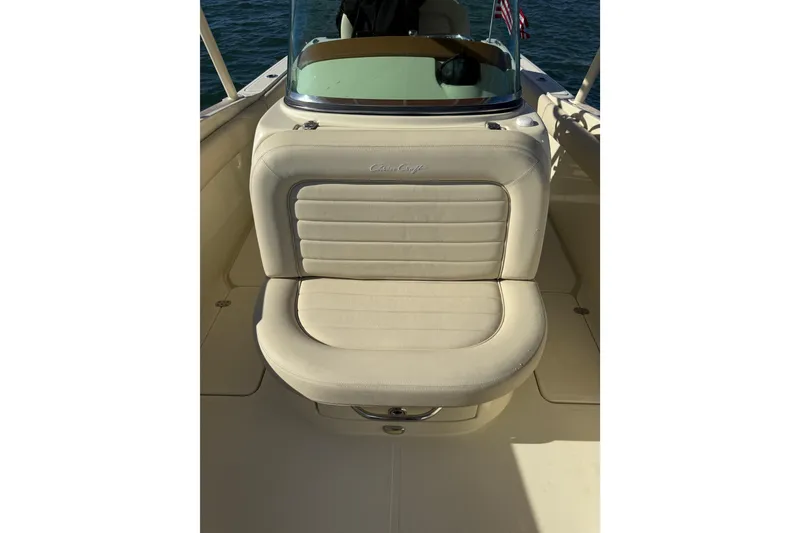 Slide: The Image of 2013 Chris-Craft Catalina 26 boat seat with beige upholstery and logo detail. - 20
