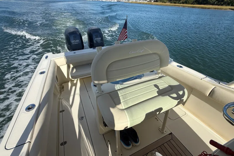 Slide: The Image of 2013 Chris-Craft Catalina 26 boat with dual engines cruising on a sunny day. - 25