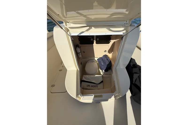 Slide: The Image of 2013 Chris-Craft Catalina 26 boat storage area with life jackets and equipment. - 32