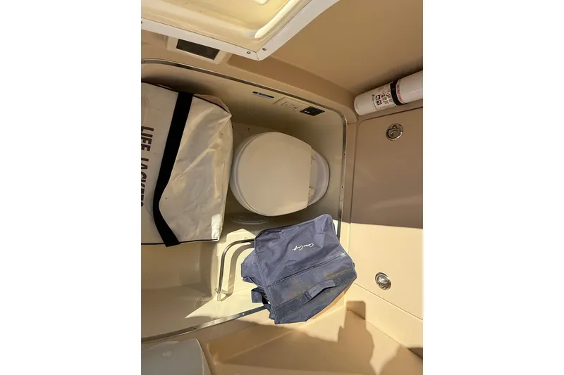 Slide: The Image of Interior of 2013 Chris-Craft Catalina 26 boat with toilet and storage items. - 33