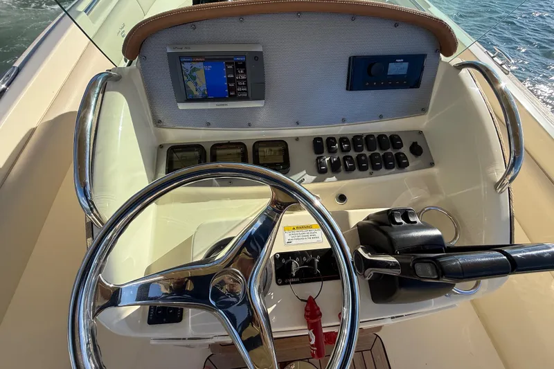 Slide: The Image of Steering console of 2013 Chris-Craft Catalina 26 with navigation display and controls. - 39