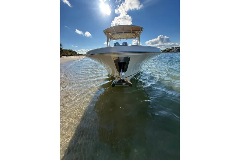 Slide: The Image of 2013 Chris-Craft Catalina 26 boat on clear water under a sunny sky. - 4