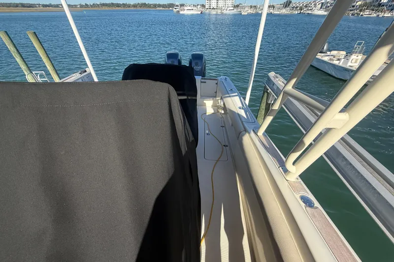 Slide: The Image of 2013 Chris-Craft Catalina 26 boat docked, showcasing deck and water view. - 42