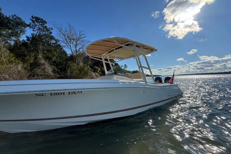 Slide: The Image of 2013 Chris-Craft Catalina 26 boat on water under clear blue sky. - 6