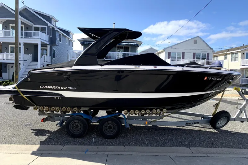 The Image of 2019 Chaparral 277 SSX boat on trailer, parked in residential area. - 0
