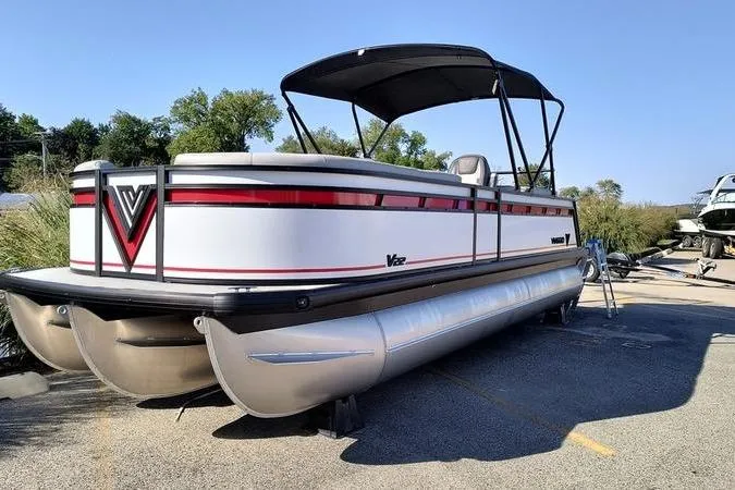 The Image of 2026 Viaggio V22U pontoon boat with canopy, parked outdoors on a sunny day. - 0