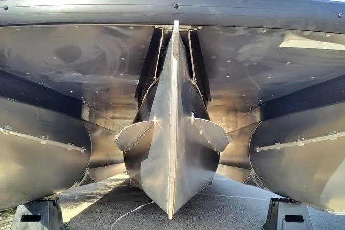 Slide: The Image of Underneath view of a 2026 Viaggio V22U pontoon boat, showcasing its sleek aluminum hull design. - 14