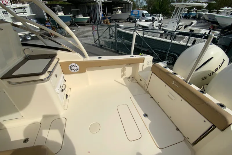 Slide: The Image of 2019 Scout 255 Dorado boat interior with Yamaha engines, docked at a marina. - 14