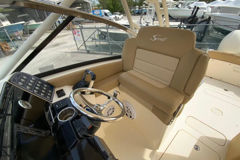 Slide: The Image of 2019 Scout 255 Dorado boat interior with steering wheel and beige seating. - 17