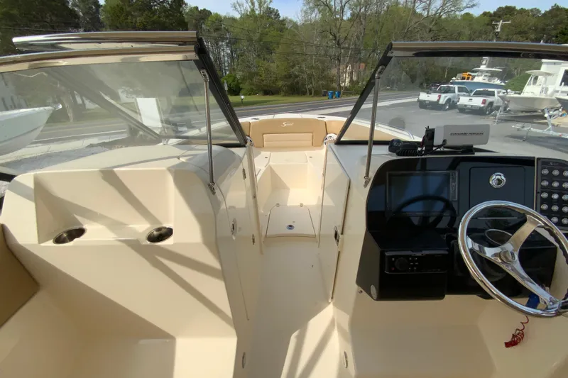 Slide: The Image of 2019 Scout 255 Dorado boat interior with steering wheel and dashboard controls. - 19